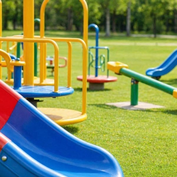 A_colorful_outdoor_playground_scene_featuring_fiberglass_pla